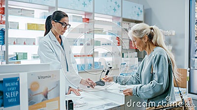 Pharmacy Drugstore Checkout Cashier Counter: Female Pharmacist Service Beautiful Senior Female Stock Photo