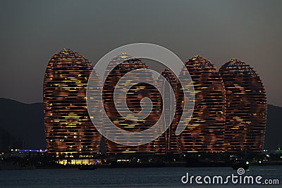 Pheonix Island Sanya, illuminated buildings.Orange Bronze, Unique modern design Editorial Stock Photo