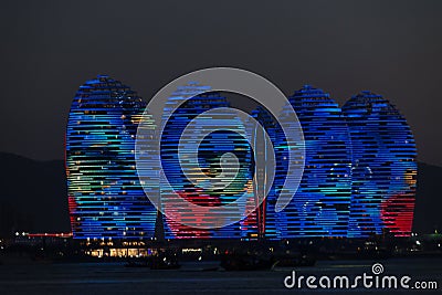 Pheonix Island Sanya, illuminated buildings.Orange Bronze, Unique modern design Editorial Stock Photo