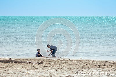 PHETCHABURI-THAILAND,DECEMBER 31 ,2022 : Unidentified Three Asian boys from same family having fun together playing in the sea Editorial Stock Photo