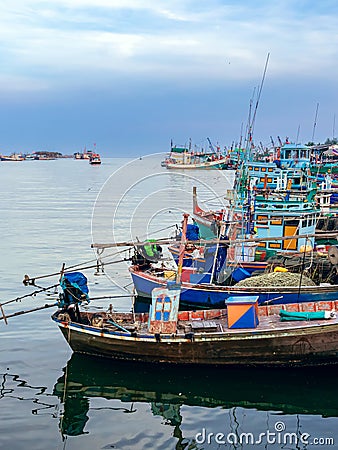 PHETCHABURI-THAILAND,OCTOBER 23, 2022 : Beautiful scenic of variety colorful fishing boats at pier with seaview in evening at Phoo Editorial Stock Photo