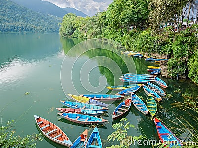 Phewa Lake in Pokhara city with boats in-shore, Nepal Stock Photo