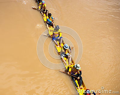 Group of Thai men sitting in arms holding a wooden paddle together Editorial Stock Photo