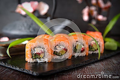 Philadelphia roll sushi with salmon, cucumber, avocado, cream cheese, tobiko caviar. Sushi menu. Stock Photo