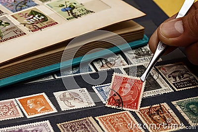 Philatelist looks at postage stamps Editorial Stock Photo