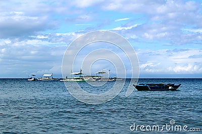 Philippine boats waiting for tourists at sea in front of hotels Stock Photo