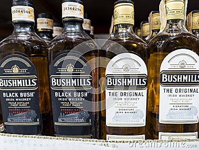 Philippines -Close-up of Bushmills Black Bush and The Original Irish whiskey bottles lined up on a retail shelf Editorial Stock Photo