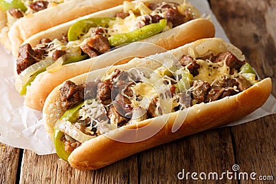 Philly cheese steak sandwich served on parchment paper close-up. Horizontal Stock Photo