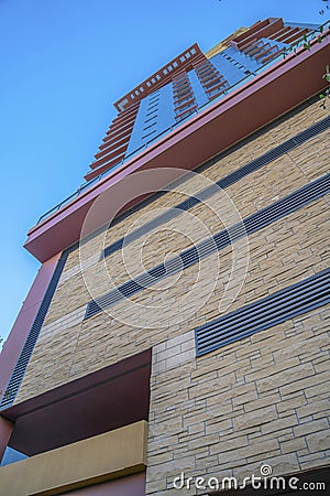 Phoenix, Arizona- Mid-rise building with stone wall cladding and wall vents Stock Photo