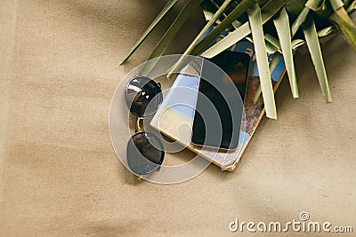 Summer vacation phone book sunglasses palm leaves chaise lounge Stock Photo