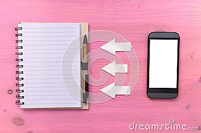 Phone book synchronization. Contact us. Call us. Note pad and mobile phone with blank screen on purple wooden background. Stock Photo
