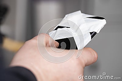 Phone with closed camera in hand. Fear of espionage, data protection. Stock Photo