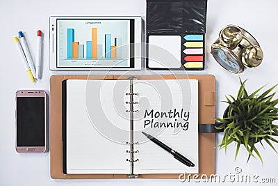 Phone,digita ltablet,cock,blank notebook with MONTHLY PLANNING word Stock Photo