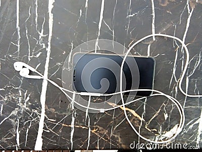 Phone with earphone place on the table Stock Photo