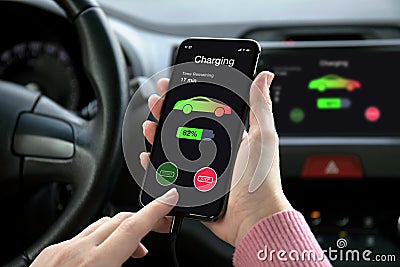 Phone in eco electric car touch multimedia system charging battery Stock Photo