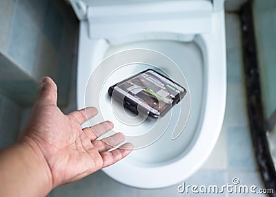 Phone fell in the toilet bowl cannot keep up,Safety concept Stock Photo