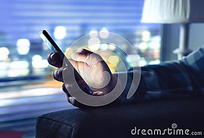 Phone with fraud text message, unknown scam call or night texting. Man using smartphone. Anonymous caller or sms scammer. Stock Photo