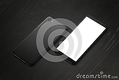 Phone front and phone back side on black wooden desk Stock Photo