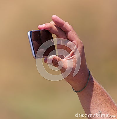 Phone in hand shoots a photo in nature Stock Photo