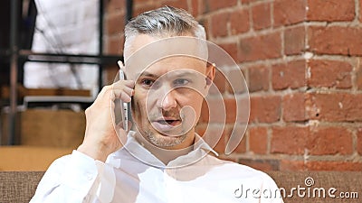 Phone Talk, Middle Age Man Answering Call At Work Stock Photo