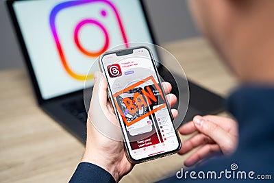 Phone with Threads Instagram app and word ban in the screen. Mass blocking of users. Bans and account freezes. Strict rules and Editorial Stock Photo