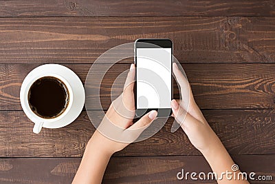 Phone white screen in woman hand on table top Stock Photo