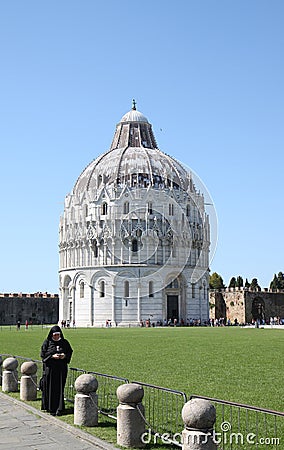 Phoning nun near Baptistry of St. John in Pisa Editorial Stock Photo