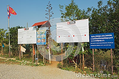 Signs set by the Mines Advisory Group at the entrance to the Site #1 of the Plain of Jars archaeological site in Phonsavan, Laos. Editorial Stock Photo