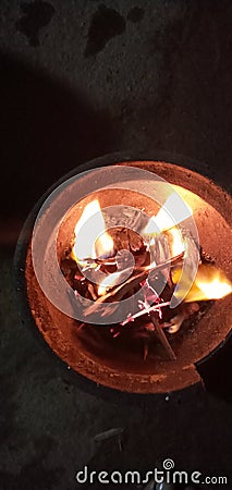 Phot of fire on the clay pot in winter sessions at our door photograph Stock Photo