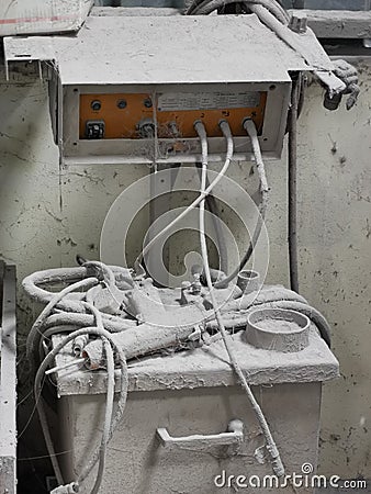 Photo of abandoned dusty powder coating machine in factory. Stock Photo