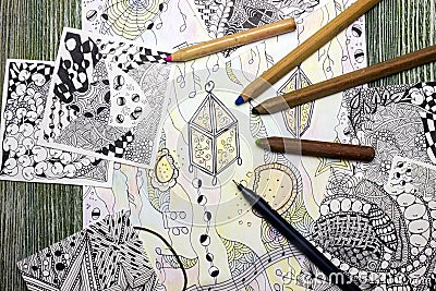 A photo of the abstract doodle lantern made of black liner pen and used pencils on wooden table. Pen strokes. Doodle, tangle illus Cartoon Illustration