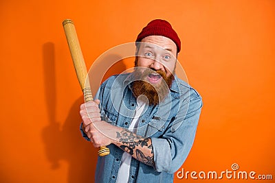 Photo of active funny baseball fan hooligan irish hooligan young guy wear beanie hat hold beat kick you bandit isolated Stock Photo