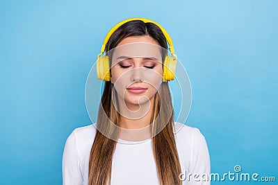 Photo of adorable concentrated focused lady listening meditation quality stereo sound isolated on blue color background Stock Photo