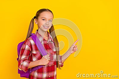 Photo of adorable funny schoolkid dressed plaid shirt pointing empty space isolated yellow color background Stock Photo