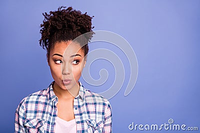 Photo of adorable tricky young woman wear plaid shirt lips pouted looking empty space isolated violet color background Stock Photo