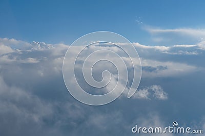 Aerial view from airplane of rain clouds and blue sky Stock Photo