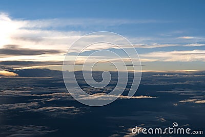 Aerial view from airplane of rain clouds and blue sky in twilight Stock Photo