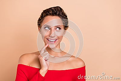 Photo of amazed excited happy young charming lady imagine look empty space plan isolated on beige color background Stock Photo