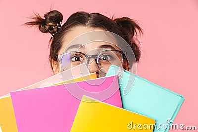 Photo amusing nice girl covering her face with exercise books Stock Photo