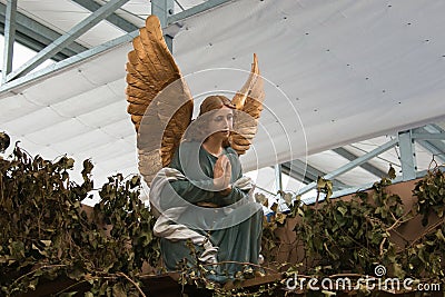 Angel with golden wings Stock Photo