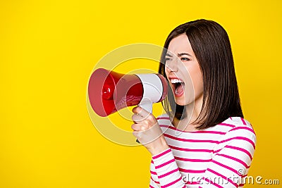 Photo of angry aggressive screaming woman striped shirt shouting in loudspeaker look at empty space isolated on yellow Stock Photo