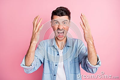Photo of angry furious young man raise hands loud scream annoyed isolate pastel pink color background Stock Photo
