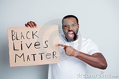 Photo of angry screaming dark skin african guy protest direct finger placard show black citizens lawlessness concept Editorial Stock Photo
