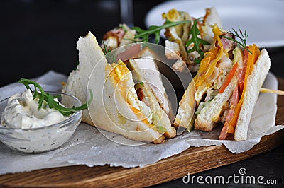 A photo of appetizing sandwiches on a wooden board Stock Photo