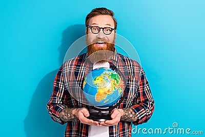 Photo of astonished funny young man wear glasses holding earth planet globus surprised discovering world isolated on Stock Photo