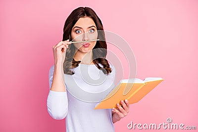 Photo of attractive student lady hold personal planner writing school college homework playing with pencil make fake Stock Photo