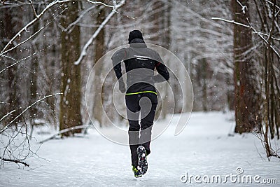 Photo from back of athlete on run in winter Stock Photo