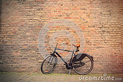 photo of the beautiful bicycle near the wonderful bricks building Stock Photo