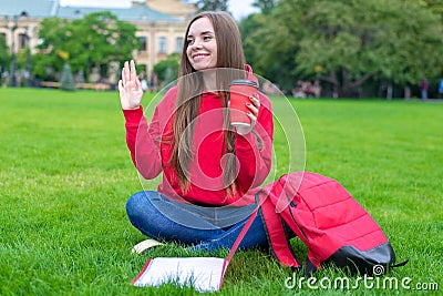 Photo of beautiful king cheerful excited funky person sitting on green grass waving palm enjoying summer drinking takeaway takeout Stock Photo