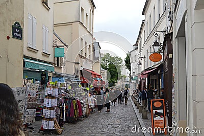 Stunning little street near Montmartre with souvenir stores and people walking Editorial Stock Photo